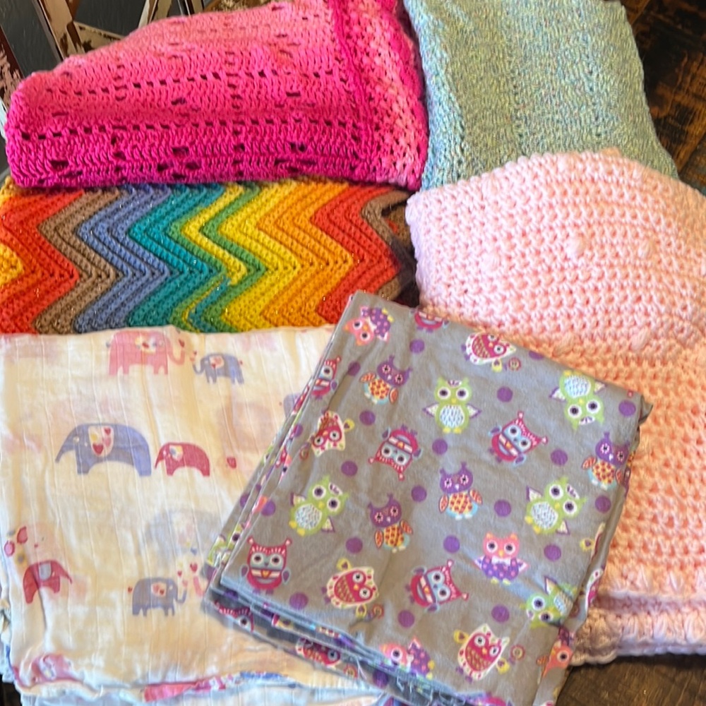 4 crocheted baby blankets and 3 large blankets